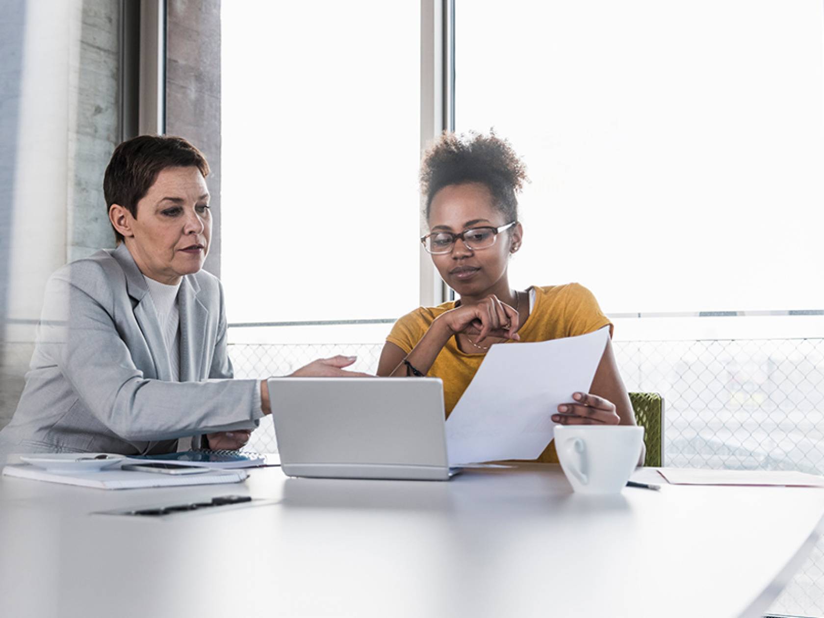 Wiki Schmuckbild 15 Zwei Frauen sitzen an einem Tisch und schauen auf einen Laptop